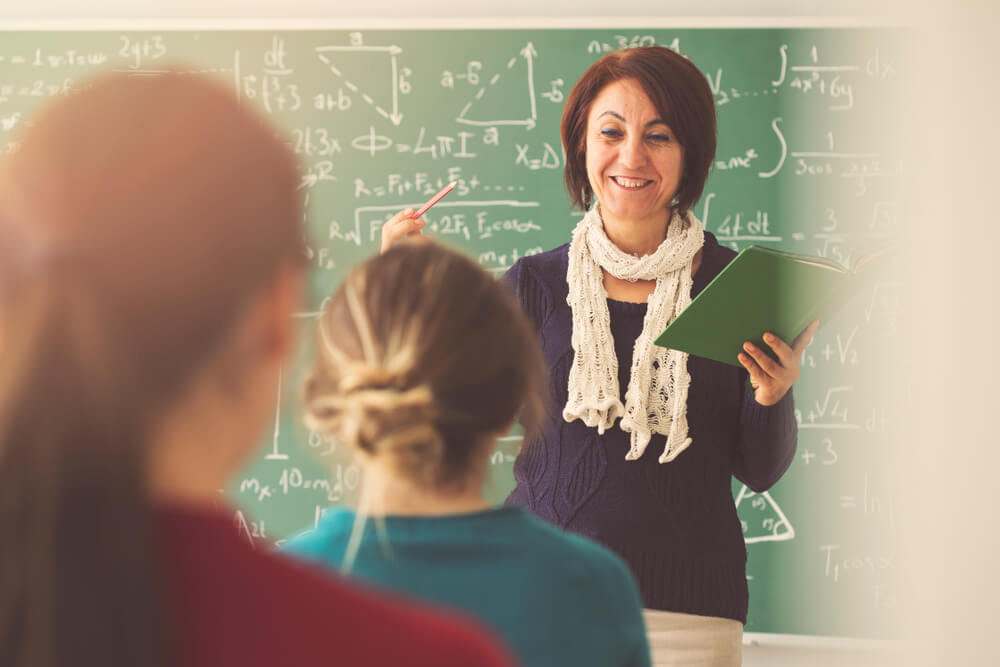 math teacher discussing in front of the class