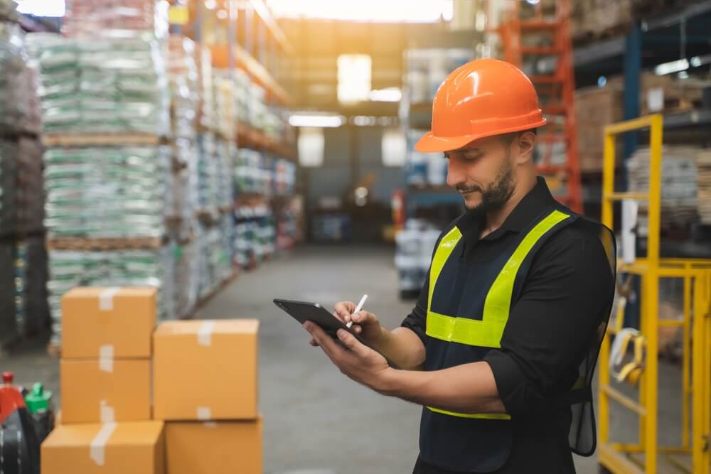 man working in logistics and checking inventory