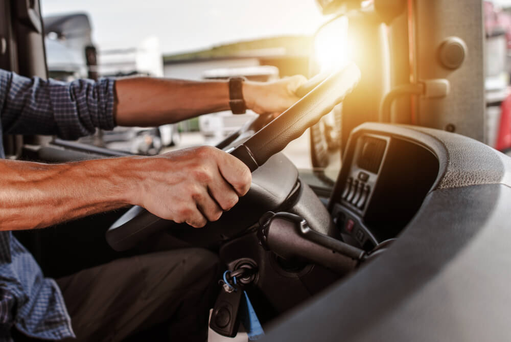 hands of a man driving a truck