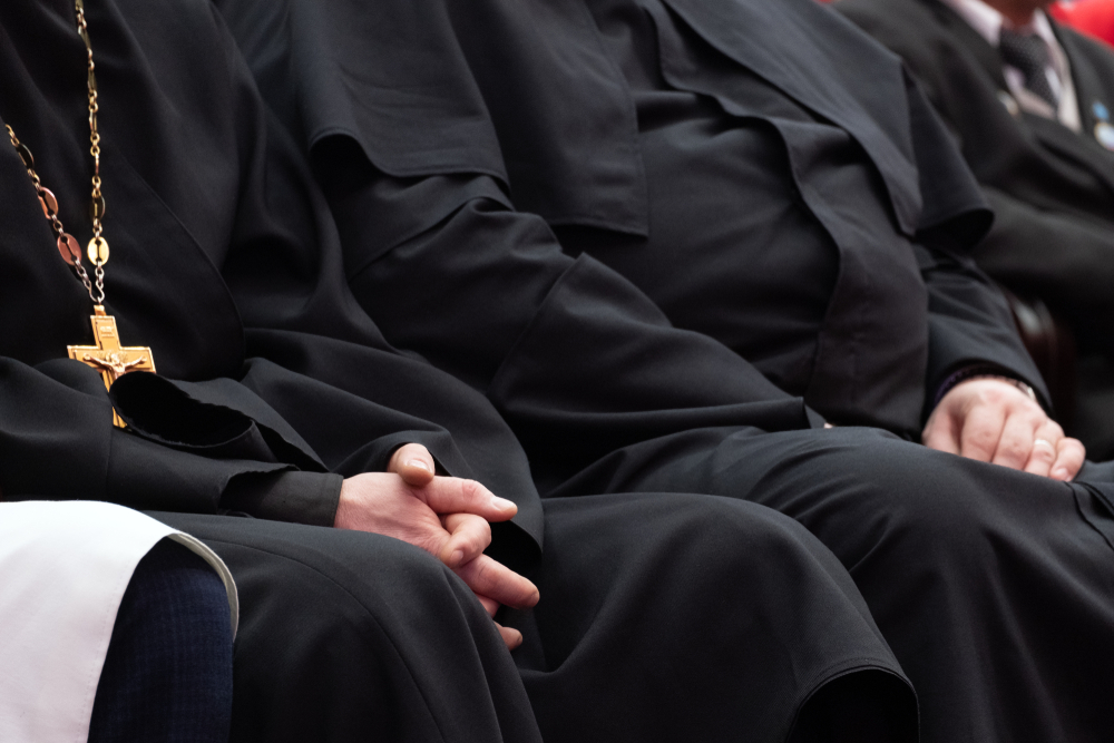 clergymen and priests sitting in church