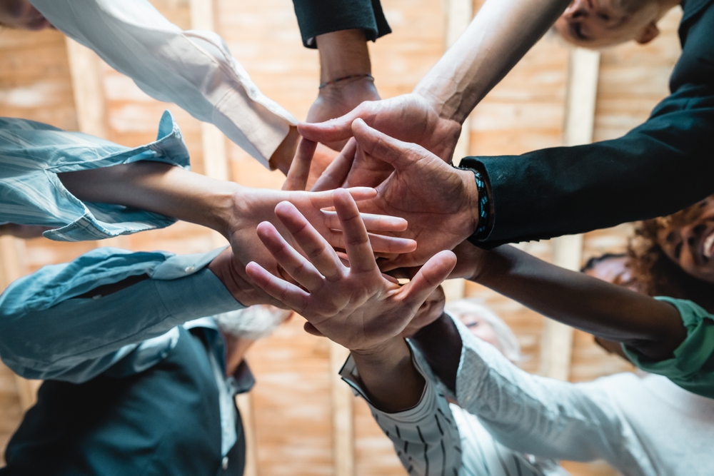 Group of business people joining hands together