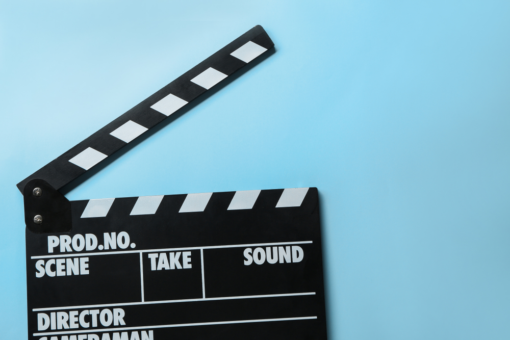 Video clapperboard on light blue background