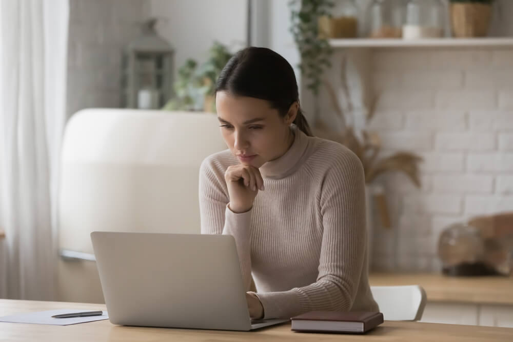 woman reading on laptop screen