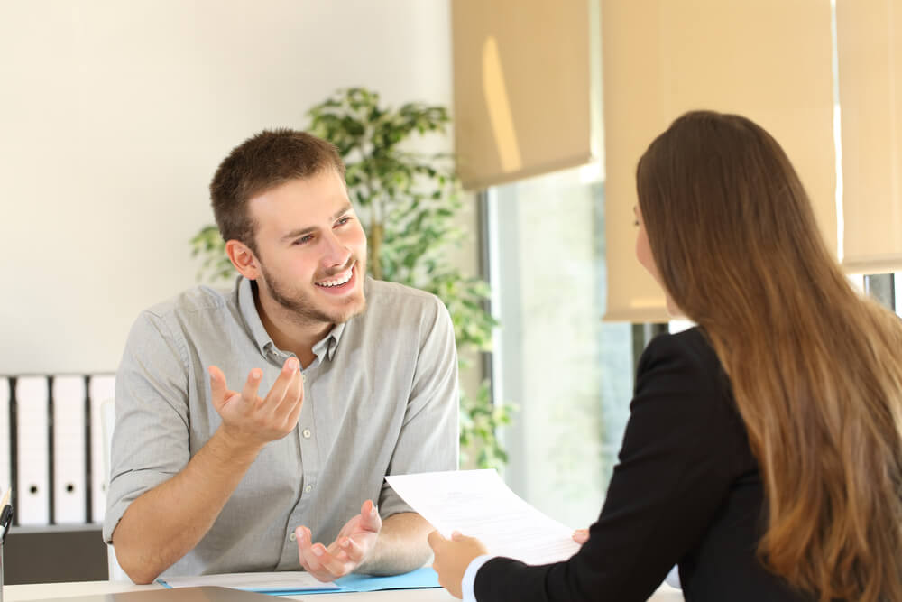 confident male applicant talking to a female recruiter