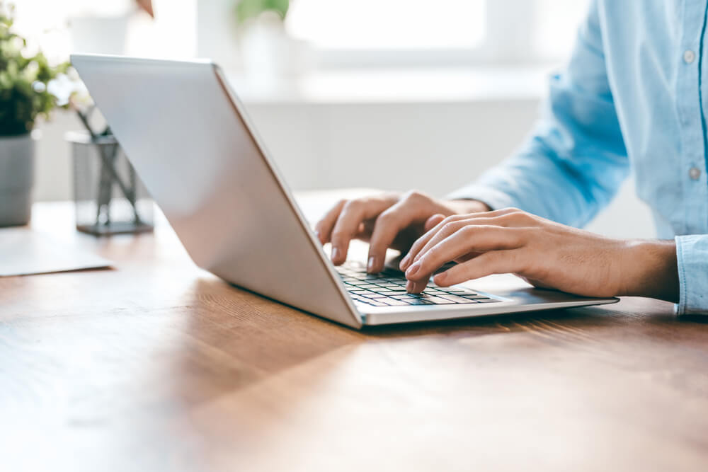 person typing on a laptop