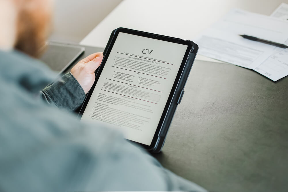 man reading a cv document on a tablet